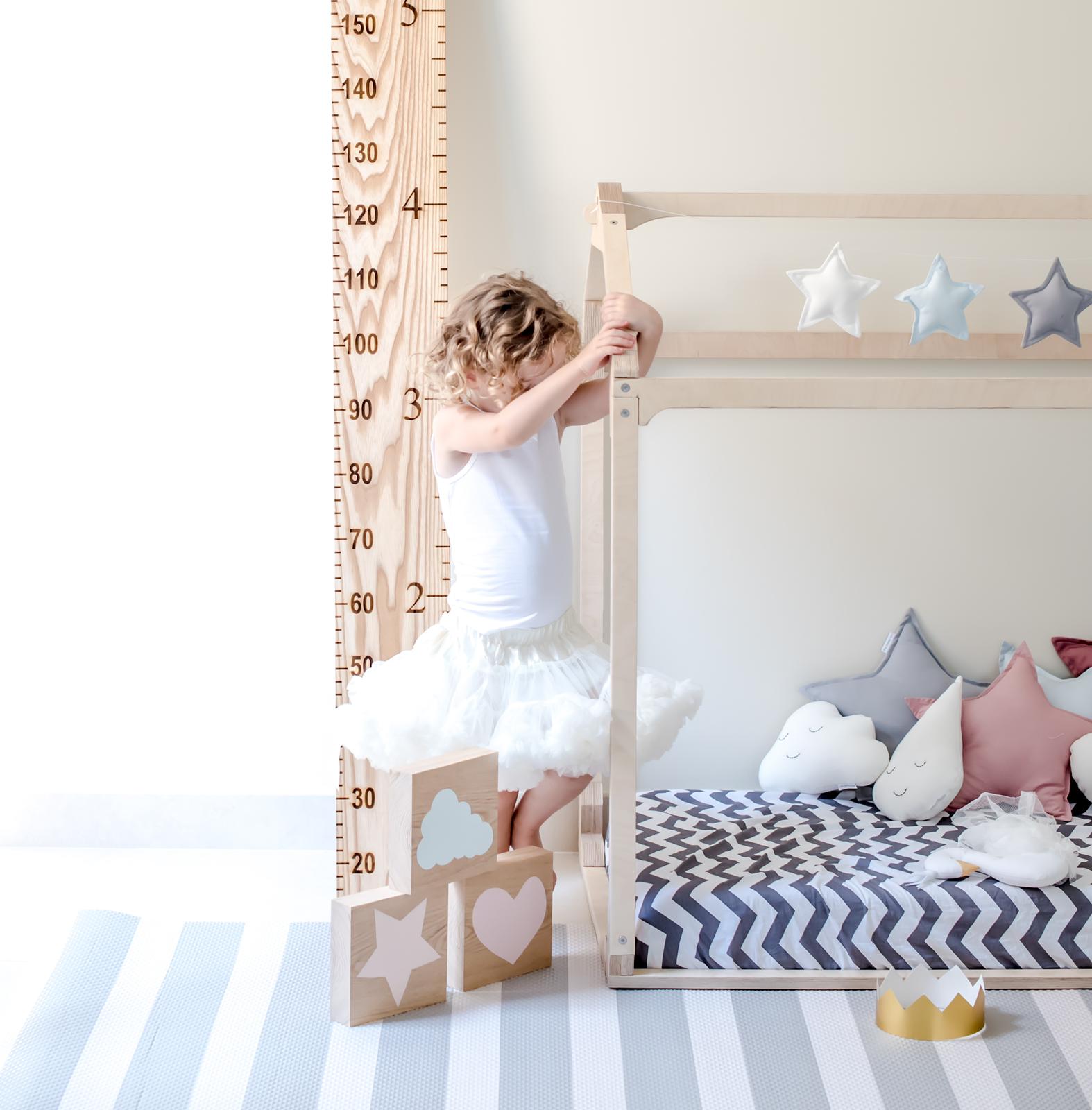 little girl laying on bumpa mat grey stripe lifestyle 